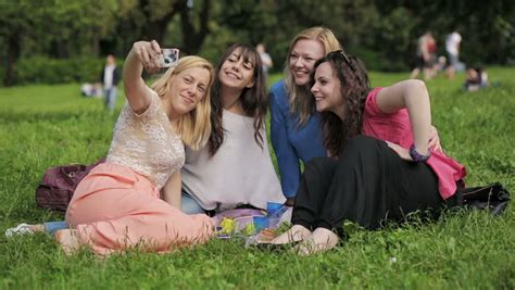 four friends taking selfie in the park friendship smartphone photo funny stock footage
