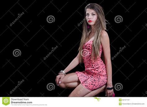 woman with very long hair wearing black stars print short dress stock