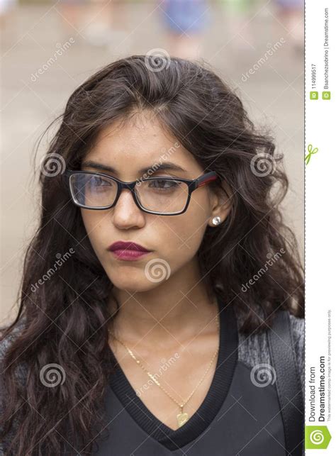 Portrait Of A Brunette Girl With Long Hair And Glasses