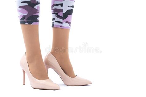 slender female legs elegant lacquered beige shoes with high heels