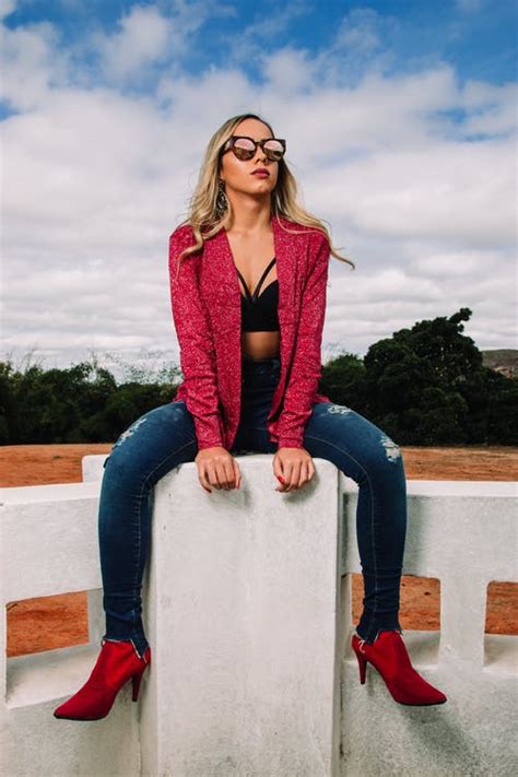Woman Wearing Red Jacket And Distressed Blue Denim Skinny