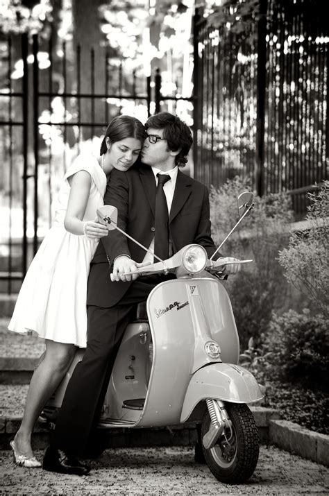 black and white photograph of couple on engagement shoot with a vespa