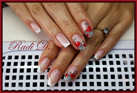 it`s all about nails french with red hearts and swirls