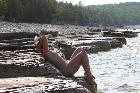 naked on the rocks by the river with hands behind head october 2007 voyeur web hall of fame