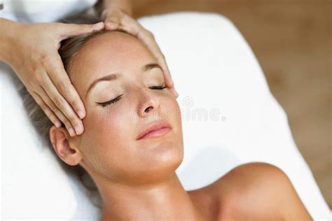 Young Woman Receiving A Head Massage In A Spa Center Stock Image