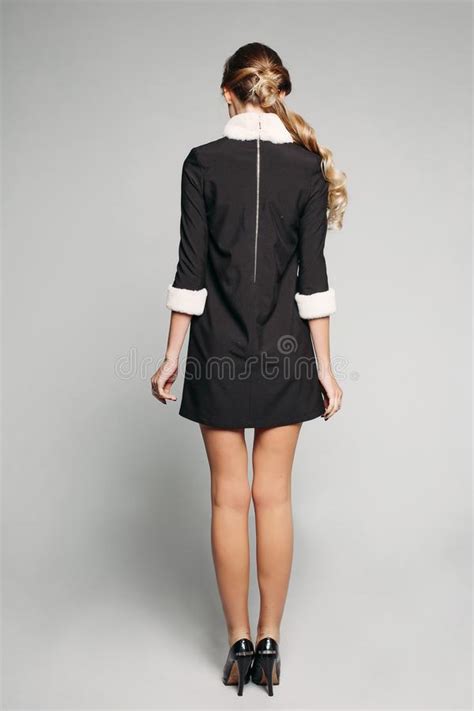 woman wearing black mini dress and high heels stock image