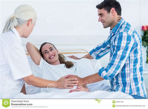 Pregnant Woman And Her Husband Having A Doctor Visit Stock