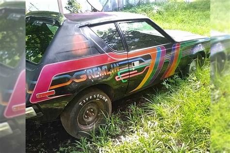car    painted  rainbow colors   parked   grass