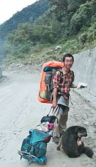 hu jian is on his way trekking to tibet in 2014 with a backpack and a hand cart filled with