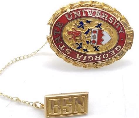 gold  red pin sitting  top   white table    chain