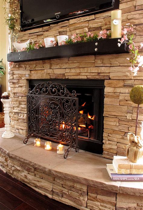 traditional light beige stacked stone fireplace design  candles  tiny flowers decorated