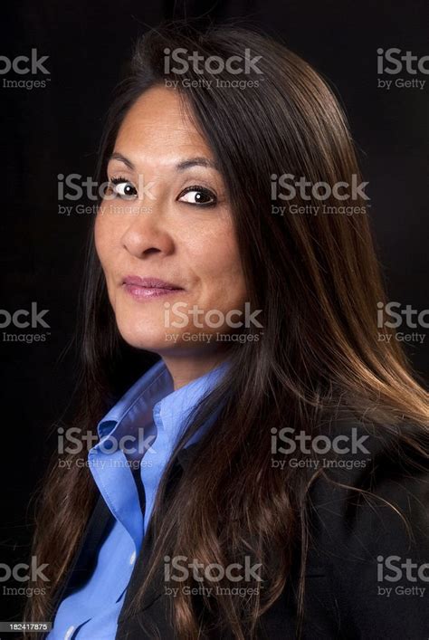 portrait of a beautiful smiling mature japanese woman on black stock