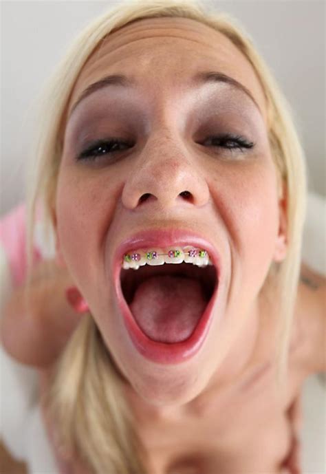 cute blonde with braces sticks her tongue out waiting for a mouth full of cum xxx photo