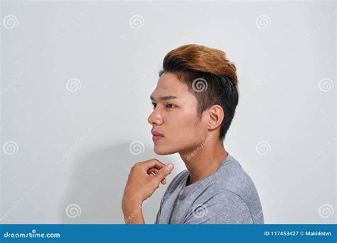 handsome young smiling pensive man standing    isolated