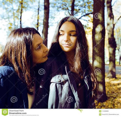 mature real mother with daughter outside autumn fall in park re stock