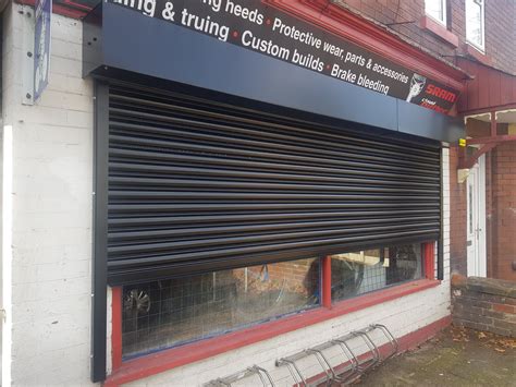 black roller shutters fitted  urmston manchester shop front shutters