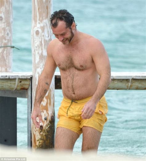 jude law shows off paunchy physique and strange facial hair as he takes