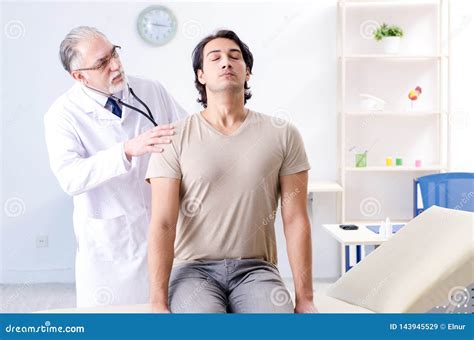 The Young Male Patient Visiting Old Doctor Stock Image Image Of