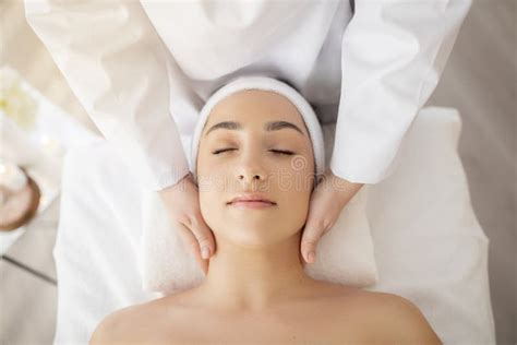 Young Indian Woman Enjoying Face Lifting Massage Top View Stock Image