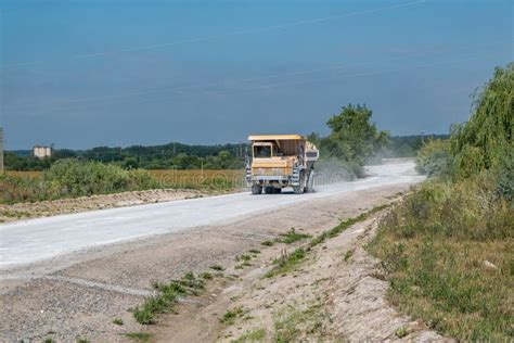 large dump truck loaded  rocks drive  dust road mining industry