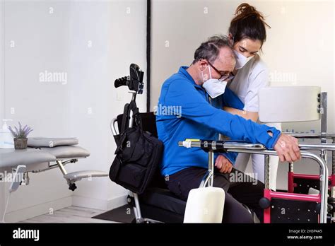 female nurse caregiver holding patient hand support disabled patient