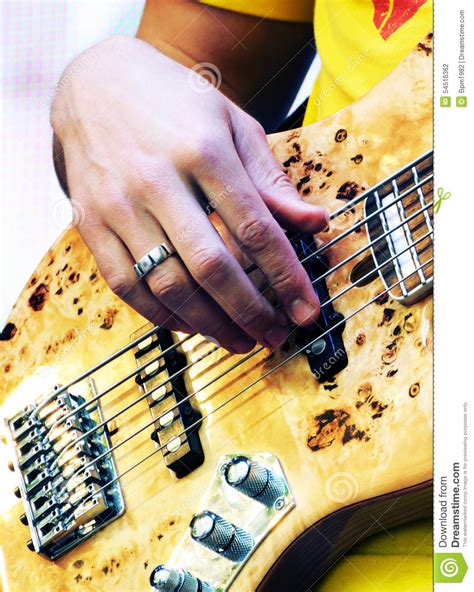Hand Of Guitarist Playing The Electric Bass Guitar Stock