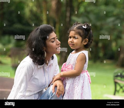 Happy Indian Mother And Daughter Playing In The Park Lifestyle Image