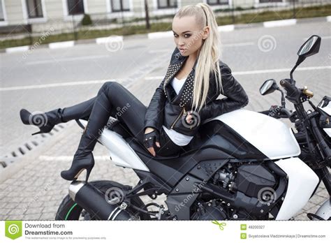 Girl With Long Blond Hair In Leather Jacket Posing On Motorbike Stock