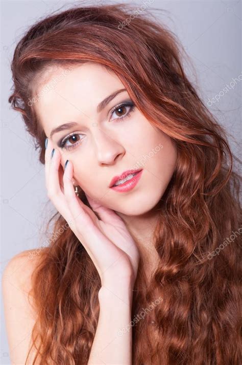 Portrait Of The Beautiful Girl With Long Curly Red Hair