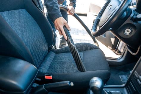 Man Vacuuming Hoovering A Car Interior By Vacuum Cleaner Cleaning