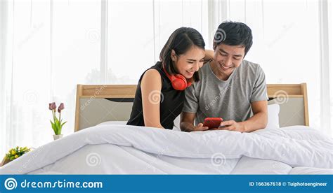Asian Couple Lovers Listening To Music And Singing On His