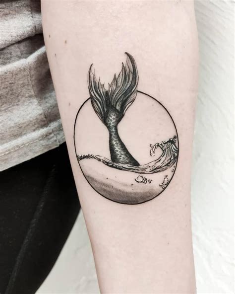 A Black And White Photo Of A Mermaid Tail Tattoo On The Right Arm With