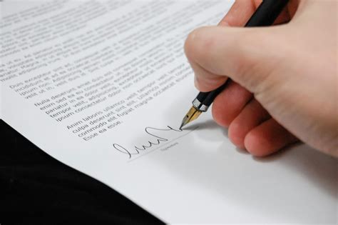 person signing  documentation paper  stock photo