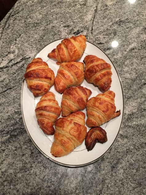 croissants are arranged on a plate on a marble counter top ready to be