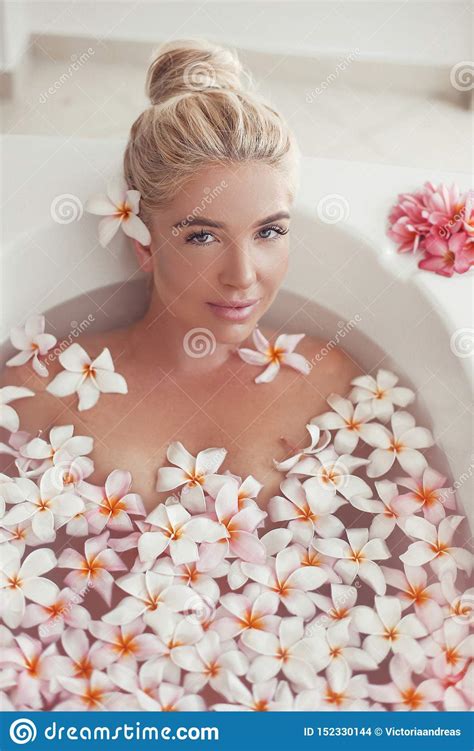 Spa Relax Blonde Enjoying Bath With Plumeria Tropical Flowers Health