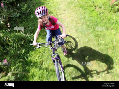 An 8 Year Old Girl Enjoys A Bike Ride Through The Countryside On A