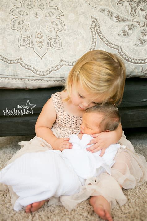 big sister holding newborn baby brother  photo session  philadelphia