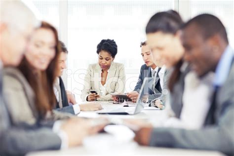 businesswoman text messaging  business meeting stock photo