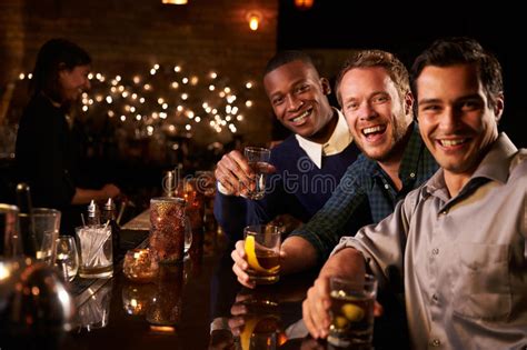 Portrait Of Male Friends Enjoying Night Out At Cocktail