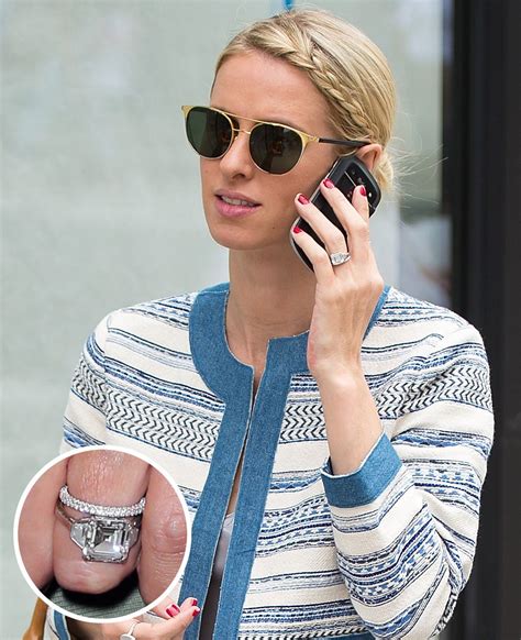A Woman Wearing Sunglasses Talking On A Cell Phone And Holding A Ring