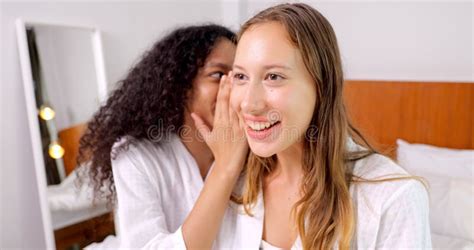 diverse female close friends sharing secrets two women gossiping at