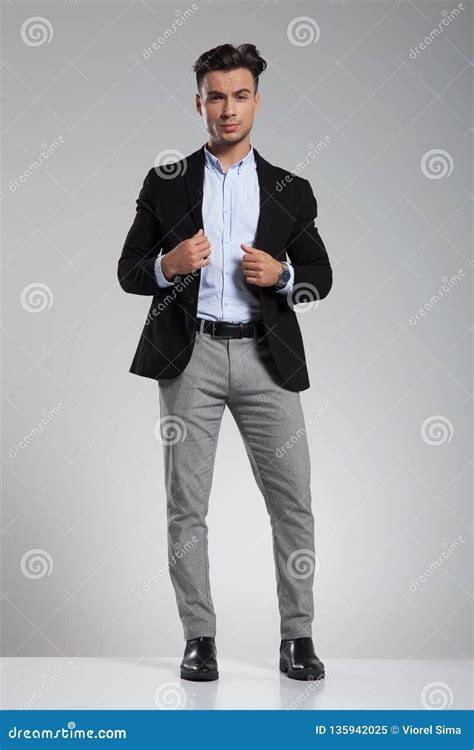 handsome smart casual man  black suit standing stock image image