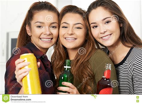 Group Of Teenage Girls Drinking Alcohol At Party Stock