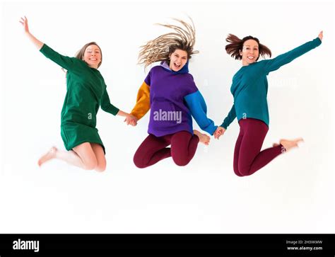 Three Happy Playful Barefoot Women Of Different Age Holding Hands