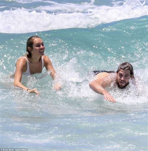 miley cyrus in skimpy bikini with liam hemsworth at beach