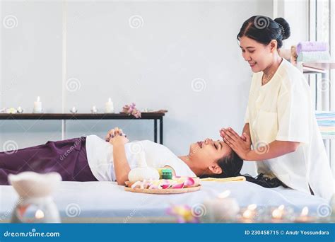 Thai Massage Therapist Giving Head And Facial Massage To An Asian Woman