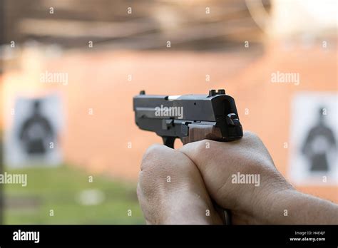 shooting   pistol man aiming pistol  shooting range stock photo