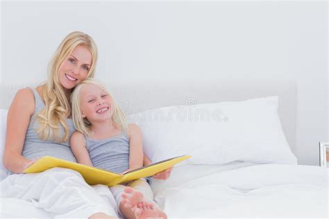 cute mother and daughter posing together stock image