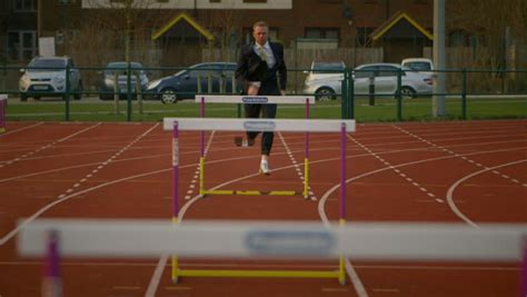 business man in suit running head on towards camera on running track stock footage video 3686369