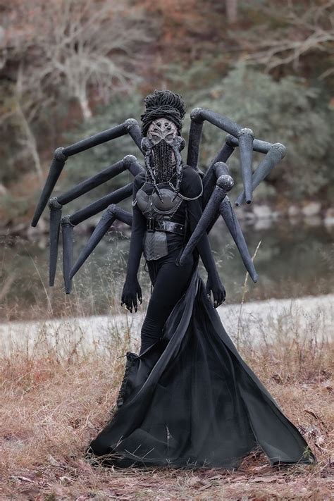 A Woman Dressed Up As A Spider In A Field